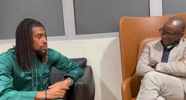 Super Eagles player, Alex Iwobi (left) and Sport Minister, John Enoh (right) in a meeting.