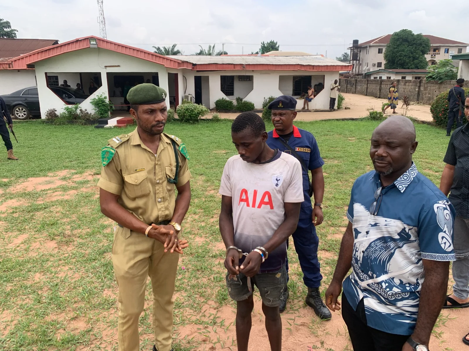 NSCDC hands over re-arrested prison escapee to NCoS in Imo 18 Re-arrested prison escapee, Chinonso Kalu (c) being handed over to the NCoS by the NSCDC in Owerri on Friday. (NAN PHOTO)