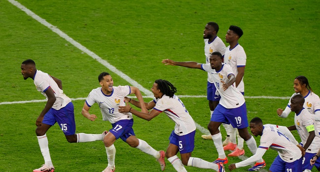 France’s players celebrate after winning the UEFA Euro 2024 quarter-final football match between Portugal and France at the Volksparkstadion in Hamburg on July 5, 2024. (Photo by Odd ANDERSEN / AFP)