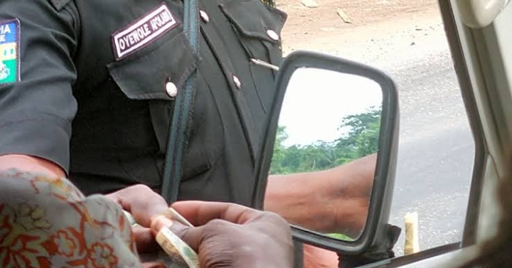 A police officer receiving bribe from a driver