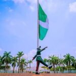 A soldier parading before the Nigeria National flag