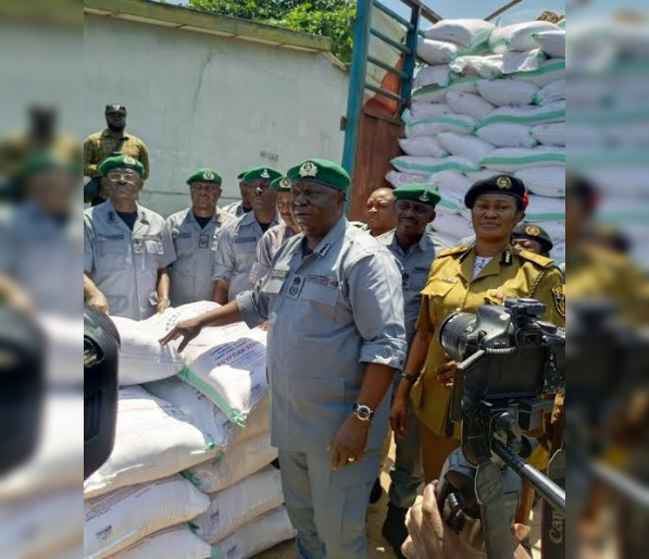 Controller of Seme Area Command of Nigeria Customs Service, Comptroller Wale Adenuga, displaying bags of flour seized by the command on Thursday in Seme.