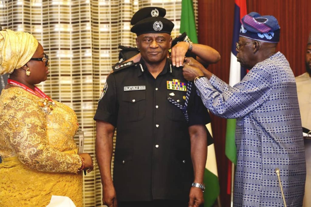President Bola Tinubu decorating the new acting IGP Olatunji Disu. Photo credit: State House Abuja