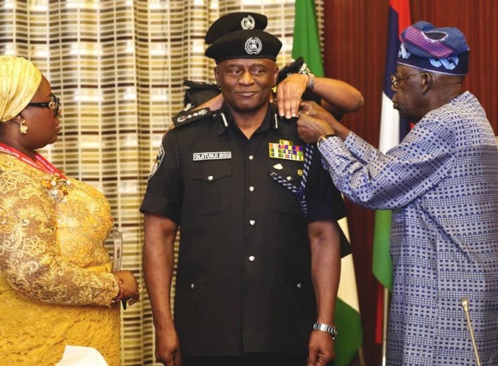 President Bola Tinubu decorating the new acting IGP Olatunji Disu. Photo credit: State House Abuja