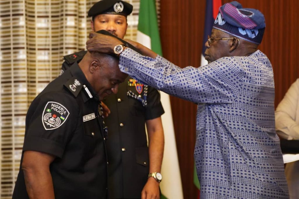 President Bola Tinubu decorating the new acting IGP Olatunji Disu. Photo credit: State House Abuja